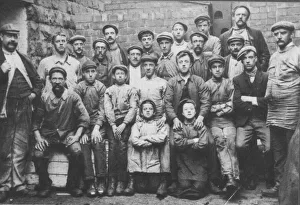 Caps Prints: A group of working class men and boys, c. 1900. Date: c. 1900