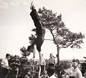 Handstand on tree stump with onlookers