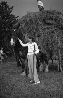Images Dated 16th February 2016: Harvest scene, woman with pitchfork