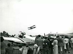 Aries Collection: A de Havilland Moth flies past the de Havilland Dove, G-?