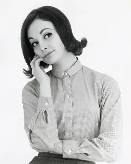 Thoughtful Prints: Head and shoulders portrait of a woman lost in thought or daydreaming. Date: mid 1960s