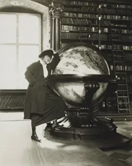 Helen Johns Kirtland leaning on a globe