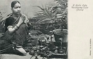 Hindu Lady worshipping Tulsi (Plants)