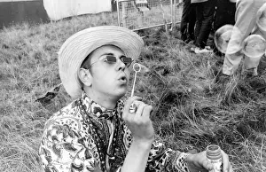 Hippy man blowing bubbles at Woburn Park