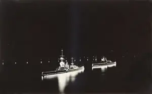 HMS Marlborough and HMS Ajax illuminated at night