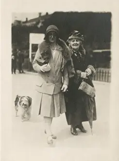 Holidaymakers (and dog) stroll along the seafront