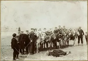 Holidaymakers with donkeys at the seaside