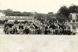 Holidaymakers enjoy a group photograph on the beach