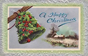 Holly with bell and snow scene on a Christmas postcard