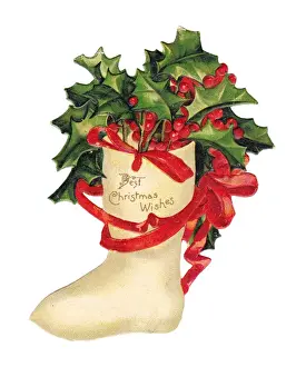 Holly and red ribbon on a cutout Christmas card