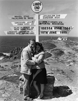 Images Dated 25th November 2016: Honeymoon couple and signpost at Lands End, Cornwall
