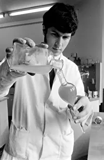 Horse doping tests -- a laboratory technician in a white coat pours a sample from a large