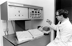 Packard Prints: Horse doping tests -- a laboratory technician in a white coat sits in front of a Packard