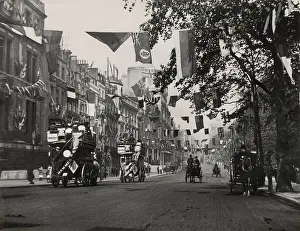Horse-drawn buses and carriages ride along London's Piccadilly, a few days before the coronation of King Edward VII. Date: August 1902