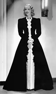 A hostess gown of black velvet, designed by Dolly Tree
