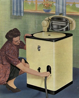 Images Dated 10th February 2016: Housewife with her new Ritemp electric washing machine