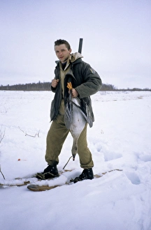 Anser Gallery: Hunter with shot wild goose (Bean goose)