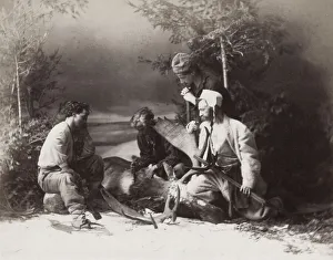 Hunters skinning a deer in snow, Canada
