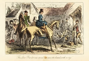 Huntsmen and women watch the fox-hounds let out of