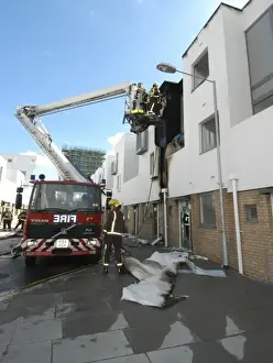 A hydraulic lift vehicle at the scene of a fire