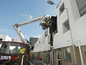 A hydraulic lift vehicle at the scene of a fire