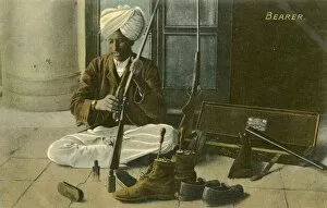 Shotgun Gallery: Indian Bearer - cleaning his Masters shoes and rifle