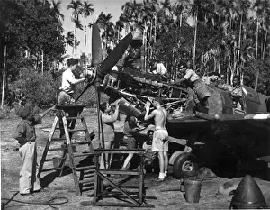 Indian and British airmen service a Supermarine Spitfire