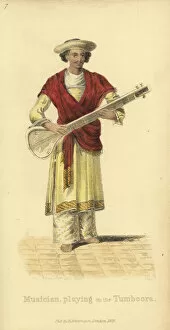 Indian man playing the tumboora (guitar)