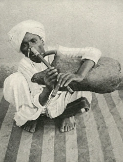 Images Dated 18th April 2016: Indian musician plays noseflute and bagpipes simultaneously