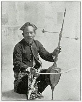 Fiddler Prints: Indonesian man playing his rehab fiddler. Date: early 1890s