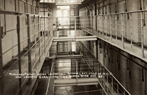 Interior of a new wing at Portland, Dorset showing cell doors, iron stairways and corridors. Wire netting was placed between balconies to prevent inmates falling to the ground. The prison opened in 1848 as a public works prison for convicts who were employed in quarries in the area Interior of cell block at Portland Prison, Dorset