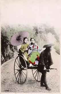 Japan - Two Japanese women and a baby take a rickshaw ride