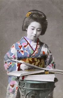 Turning Prints: Japanese Geisha looking through a picture book