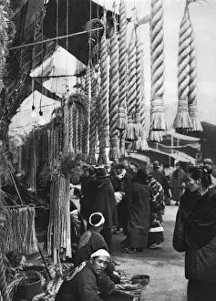 A Japanese man sells straw ropes at a market