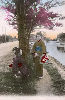 Two Japanese women by the side of a canal / river - Japan