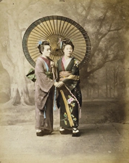 Two Japanese women, full-length studio portrait with backdro Two Japanese women, full-length studio portrait with backdro