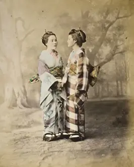 Two Japanese women, full-length studio portrait with backdro