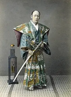 Japense samurai (actor) with a clock, Japan, circa 1880s