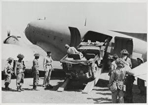 Collected Collection: Jeep being loaded into the fuselage of a Dakota transport pl