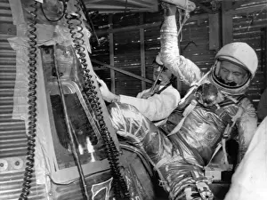 Climbs Prints: John H Glenn climbs out of his Mercury space capsule