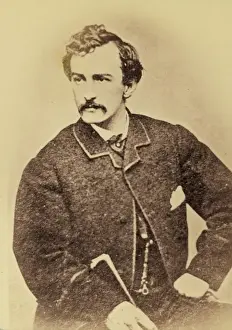 Wilkes Prints: John Wilkes Booth, half-length portrait, facing left and hol