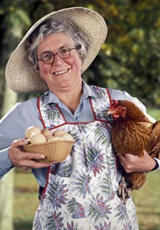 Images Dated 8th August 2019: Jolly farmers wife with hen and eggs