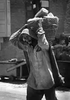 Jammu Prints: Kashmir - ragged man carries bricks in basket