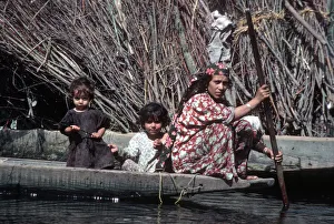 Images Dated 27th August 2019: Kashmir, River Jhelum - woman paddles a wooden boat