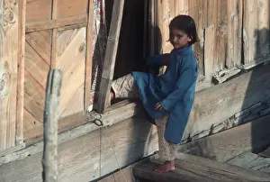 Jammu Prints: Kashmir, Srinagar, Dal Lake. A little girl with bare feet