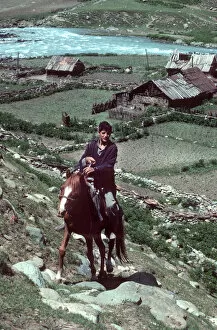 Horseman Gallery: Kashmir - young horseman rides up steep hill
