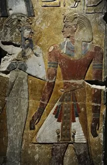 Divinity Collection: King Seti I in front of the God Osiris. Fragment of a pillar