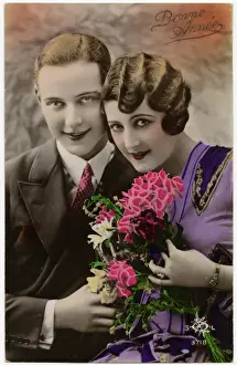 Kitsch New Years Greetings postcard featuring a young couple