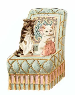 Two kittens on a chair on a cutout Christmas card