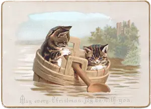 Two kittens in improvised boat on a Christmas card